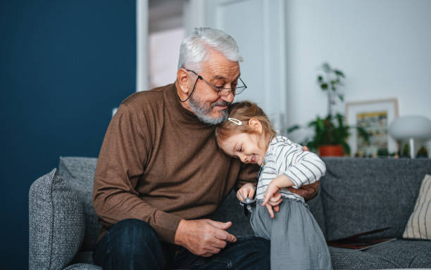 istock Loving Grandfather Hugging His Granddaughter While Playing and Spending Quality Time Together 1488334864