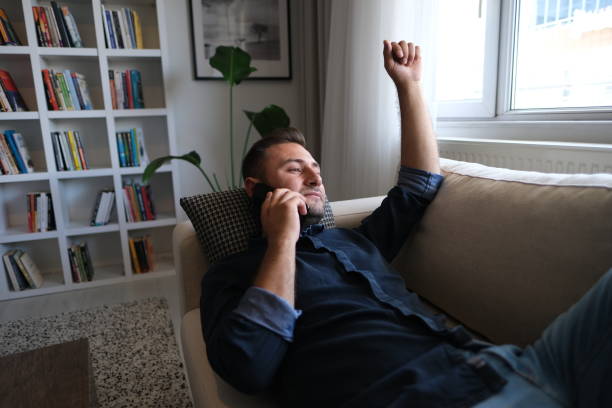 istock Businessman talking on mobile phone by window 1488335010