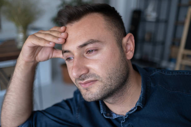 istock Sad man with stress holding back the tears. 1488336586