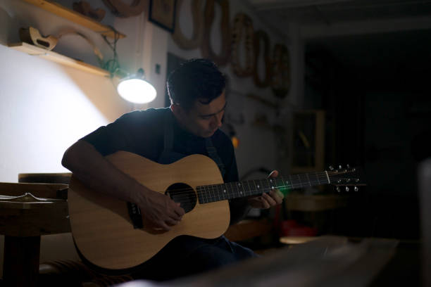Guitar maker is making guitar at workshop. Guitar maker is making guitar at workshop. Custom guitar and small business concept. acoustic guitar tattoos stock pictures, royalty-free photos & images
