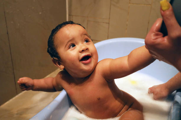 istock Baby boy bath time with mother. 1488336903