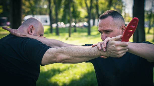 istock Knife attack self-defense. Techniques of disarming knife attacker 1488337059