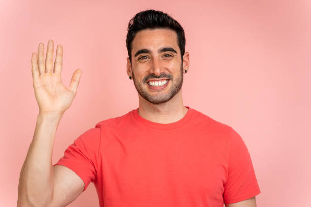istock Friendly man waving in a studio shot. 1488341266