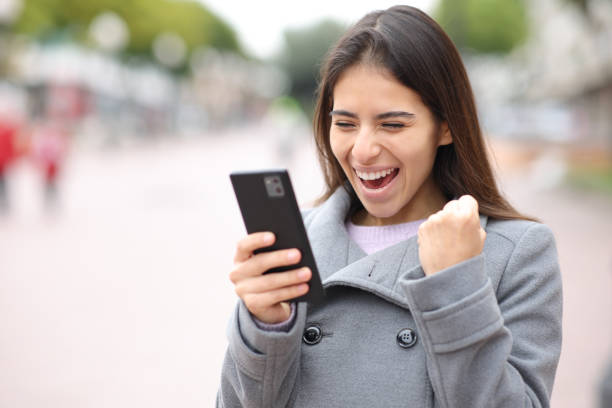 istock Excited woman checking content on phone 1488341341