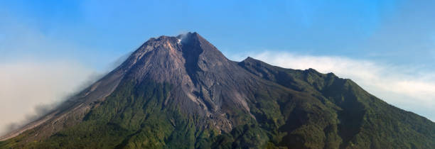 istock View of Mount Merapi Volcano erupting, Yogakarta region, Central Java, Indonesia. The active lava flows and smoke can be seen on the left flank, 1488341558