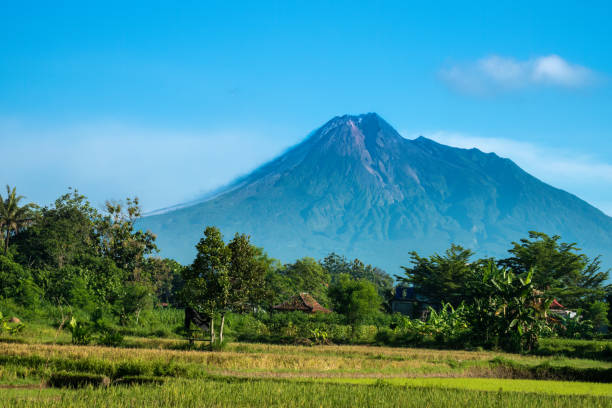 istock View of Mount Merapi Volcano erupting, Yogakarta region, Central Java, Indonesia. The active lava flows and smoke can be seen on the left flank, 1488341559