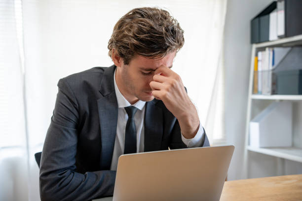 istock Young businessmen are tired and stressed from working by computer. Man has headache, eye strain, blurry vision, Migraine, office syndrome problem. 1488342584