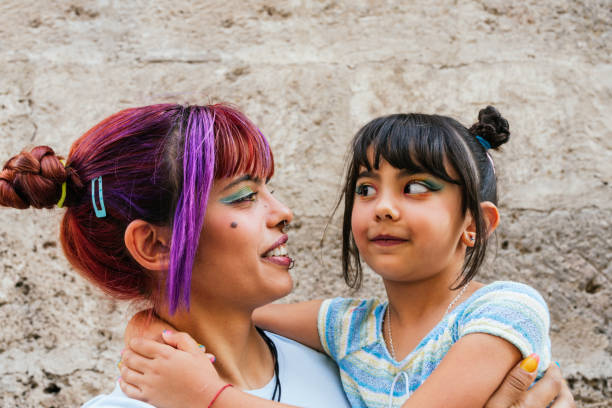 A mother and daughter looking each other in the face stock photo
