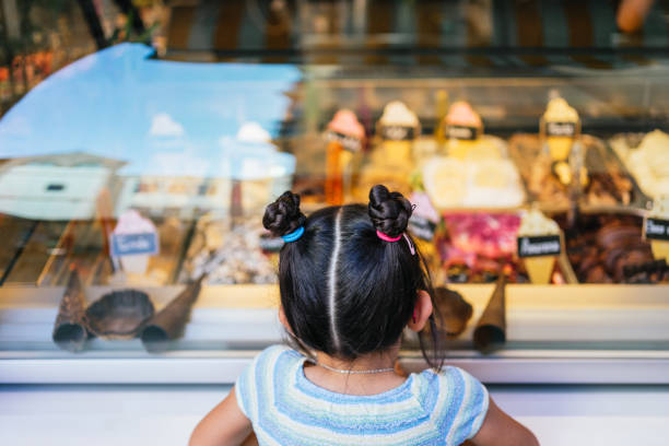 Girl choosing an ice cream in an ice cream shop. stock photo