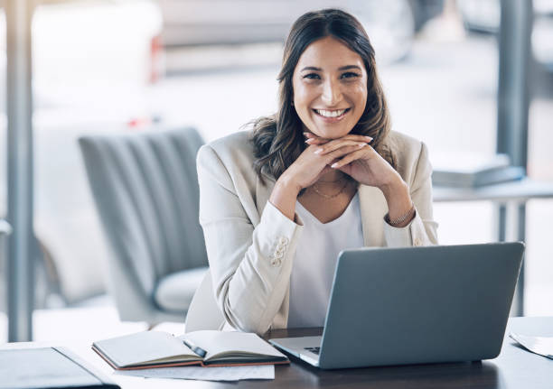 Woman, portrait and laptop in office planning, legal consulting or policy review feedback in corporate law firm. Smile, happy and attorney lawyer on technology in case research or schedule management stock photo