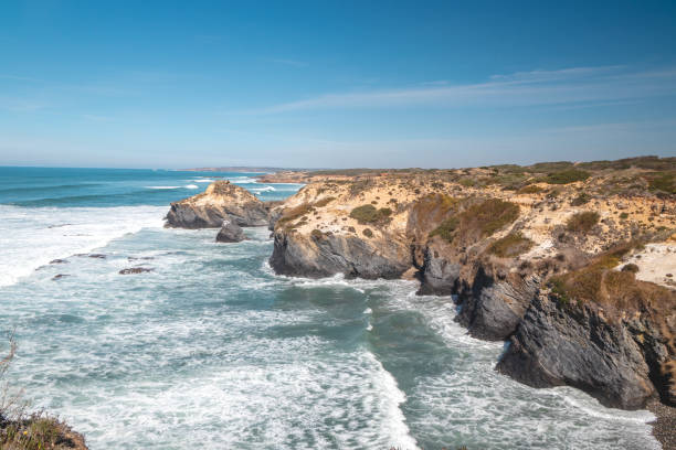 Mountainous and rocky Atlantic Coast during sunny day in the Odemira region, western Portugal. Wandering along the Fisherman Trail, Rota Vicentina stock photo