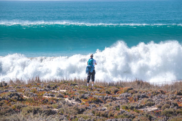 Watching huge waves roaring across the island in the Odemira region, western Portugal. Wandering along the Fisherman Trail, Rota Vicentina stock photo