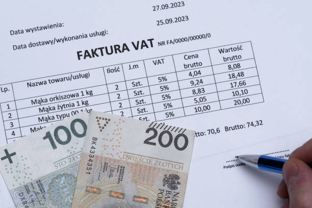 istock Signing an invoice with money on it 1488346728