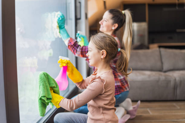 istock Daughter and mother cleaning house 1488346742