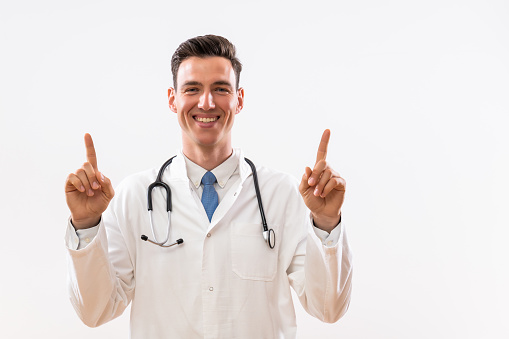 Portrait of young doctor  pointing.