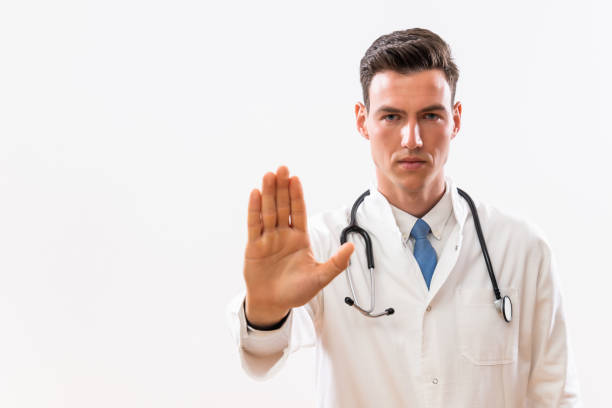 istock Doctor showing stop sign 1488347520