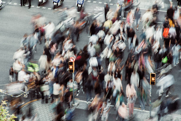 istock Crowd of people walking at zebra crossing. 1488347840