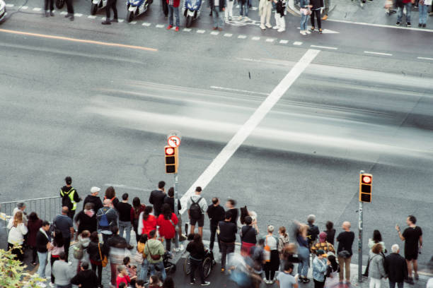 istock Crowd of people walking at zebra crossing. 1488347933