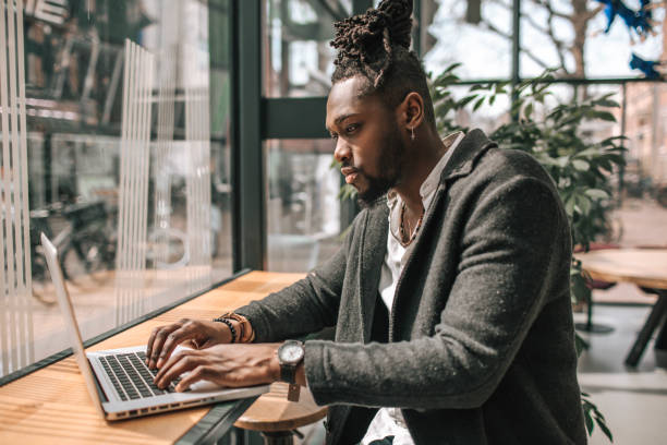 istock Handsome black adult student using AI A.I. on a laptop computer 1488348442