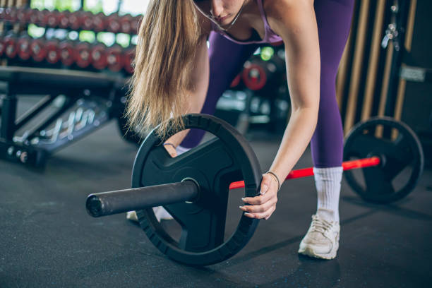 istock Young woman athlete preparing for weight lifting 1488348797