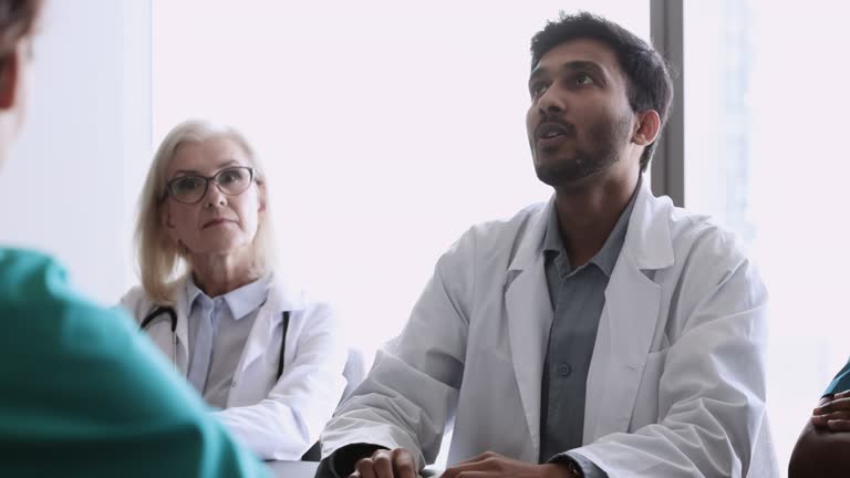 Indian doctor talking to colleagues during medical council