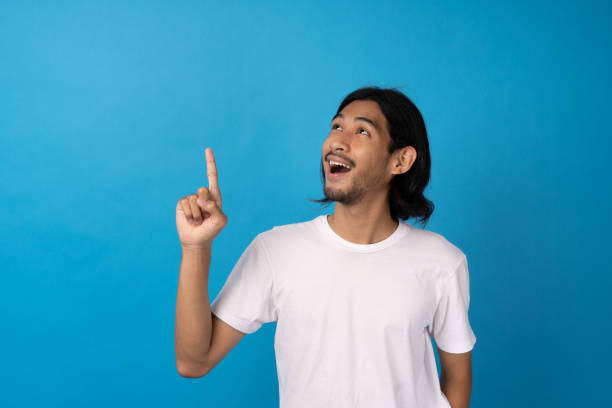 istock A bearded young man with a shocked expression, opening mouth, staring up, pointing finger upwards. Smile man saying Wow, it is unbelievable. Concepts, people and emotions 1488351381