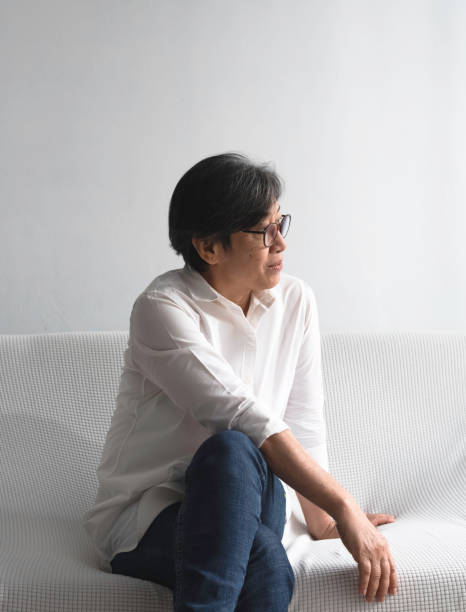 istock Old lady smart with wrinkle on her face,sittng on sofa and looking at the right side 1488351479