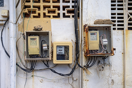 Galle, South Province, Sri Lanka - February 10th 2023:  Electric meters and main switches on the façade of an old house in a small street