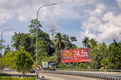 Galle, Southern Province, Sri Lanka - February 9th 2023: From the highway just outside Galle. In Sri Lanka there is no or very little regulation of where you can put your billboards