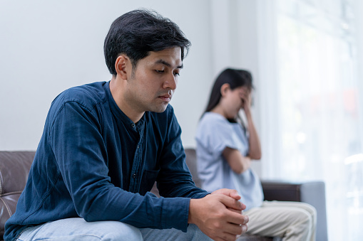 Asian man are disappointed and saddened after an argument with wife. Asian couples are having family problems resulting in divorce. Lover broken and Love problem