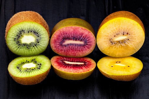 sliced green ripe kiwi, sliced green kiwi fruit on a wooden board