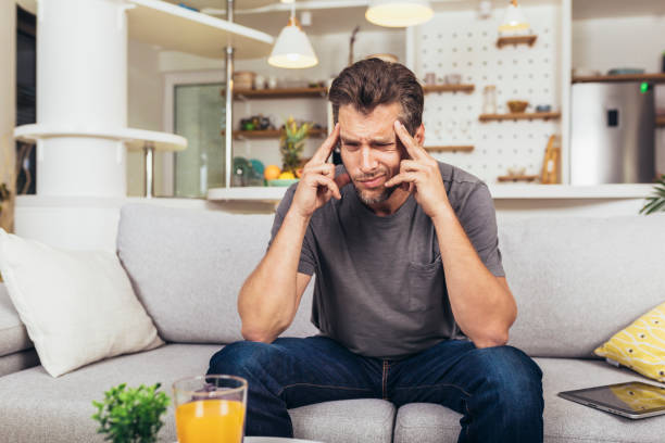 istock Young man suffering from strong headache or migraine 1488355415