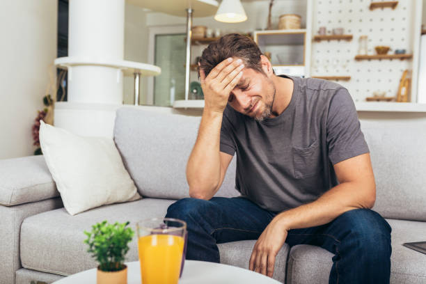 istock Young man suffering from strong headache or migraine 1488355419