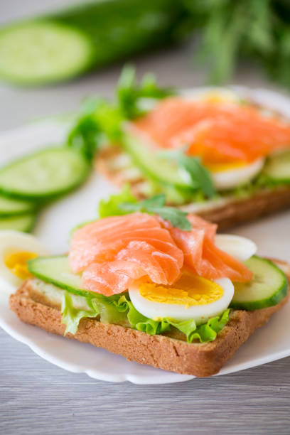 istock fried toast with lettuce, egg, cucumbers and red fish in a plate. 1488355771