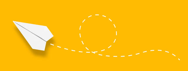 istock Paper airplane with a dashed line on yellow background 1488357134