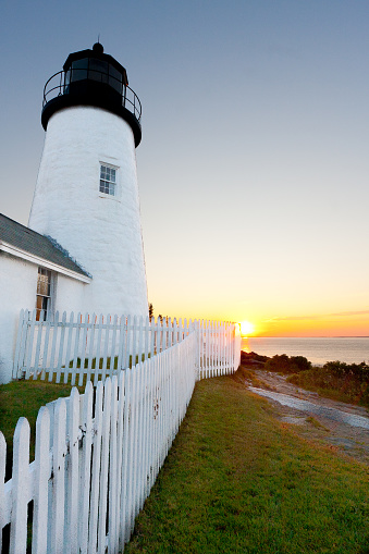 Rising sun against iconic Pemaquid Point Lighthouse