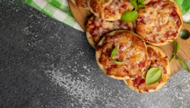 istock pizzetta - Italian mini pizza with tomato sauce, mozzarella cheese and salami. selective focus. Homemade Mini Pizza 1488357812