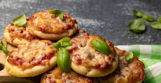 istock pizzetta - Italian mini pizza with tomato sauce, mozzarella cheese and salami. selective focus. Homemade Mini Pizza 1488357821
