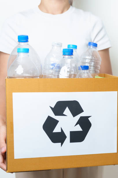 istock Volunteer keep plastic bottle into paper box at home or office. Hand Sorting Recycle garbage. Ecology, Environmental, pollution, Dispose recycling, waste management and trash Separation concept 1488357965