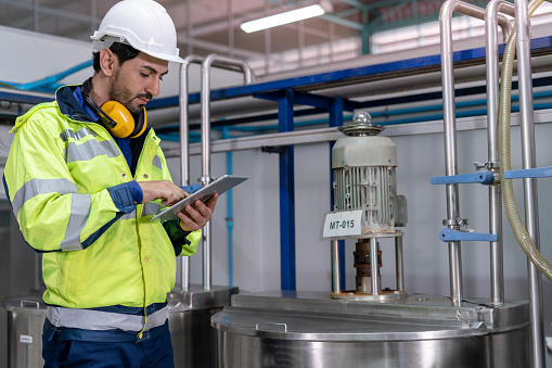 Machine engineers inspect machines and sterilizers in food factories or factory drinking water plants. Machine maintenance