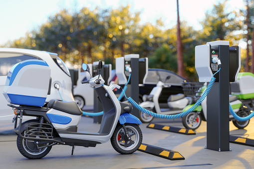 Clean Energy Concept. Close-up View Of Charging Electric Motorcycle In Parking Lot. 3D Rendering