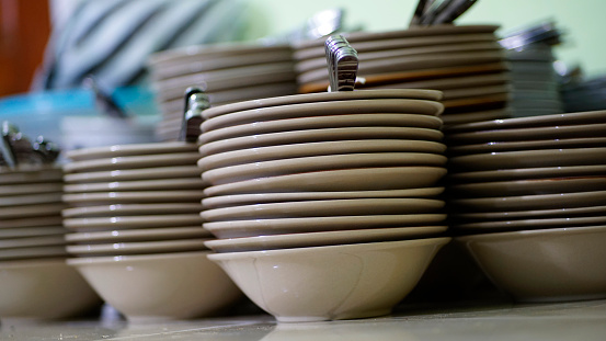 A stack of dirty dishes on black.