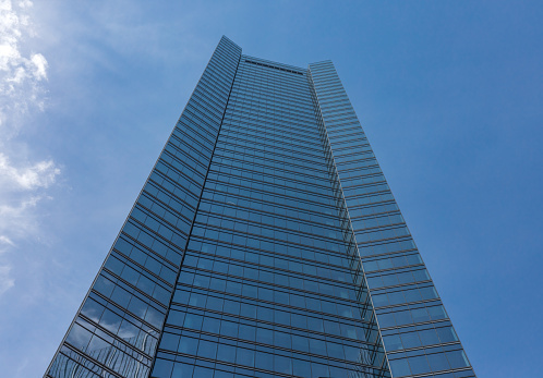 Generic all glass office building set against blue sky on nice day