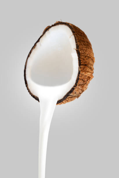 istock Coconut milk pouring front view isolated on white background 1488364298