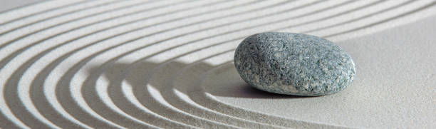 Japanese zen garden with stone in textured sand stock photo