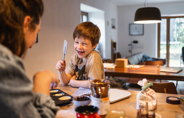 istock Mother and son preparing muffins 1488367157