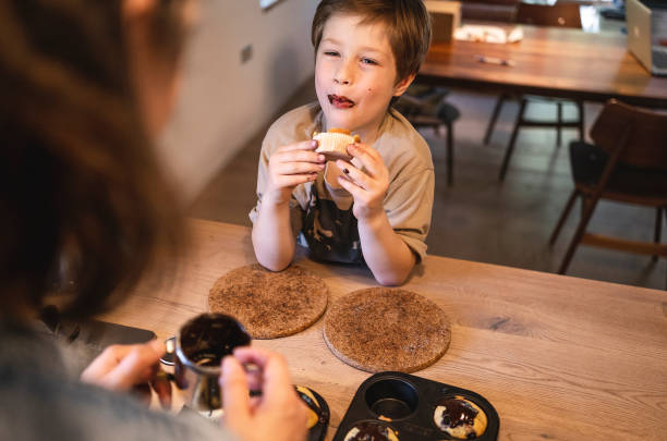 istock Mother and son preparing muffins 1488367172