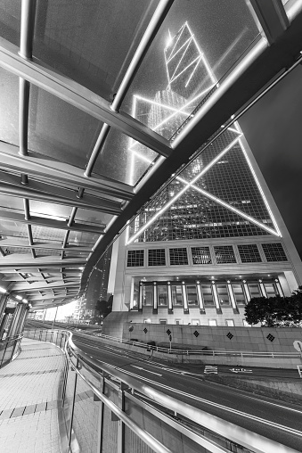 Modern pedestrian walkway and traffic in downtown of Hong Kong city at night