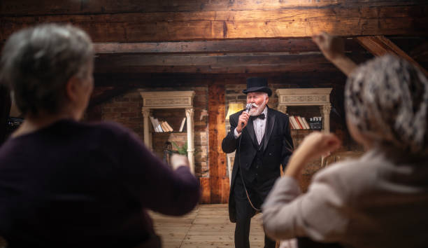 istock Senior man actor performing on stage for a an audience 1488369128
