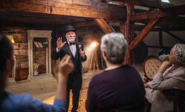 istock Senior man actor performing on stage for a an audience 1488369142